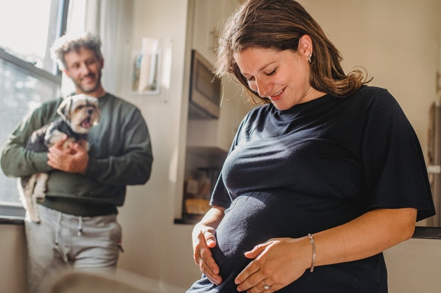 smile pregnant mom hold her belly