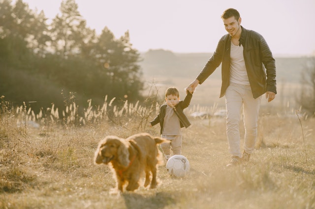 Father and son playing together holding hands