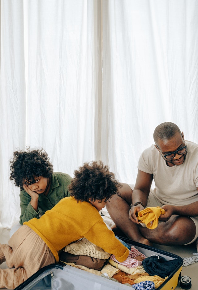 dad with his kids packing for travelling