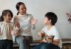 Mom and kids playing guitar together