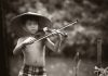 small boy playing biola