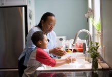 boy doing hand wash with his mom