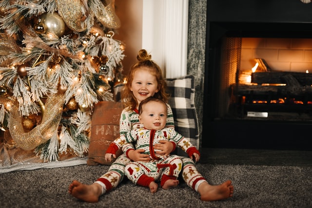 little sister and brother wearing twinning pajamas for christmas