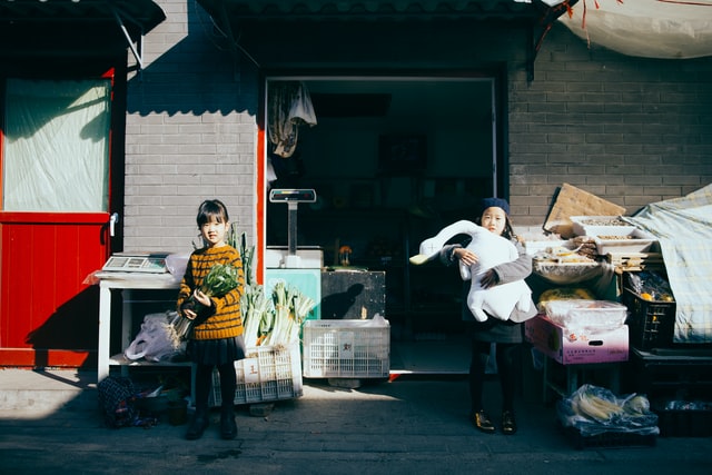 Two little girls in front of the shop