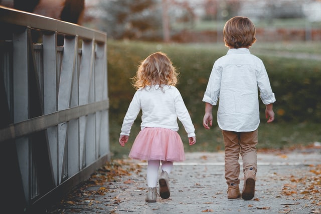 little girls wearing legging while his brother wearing khaki trousers