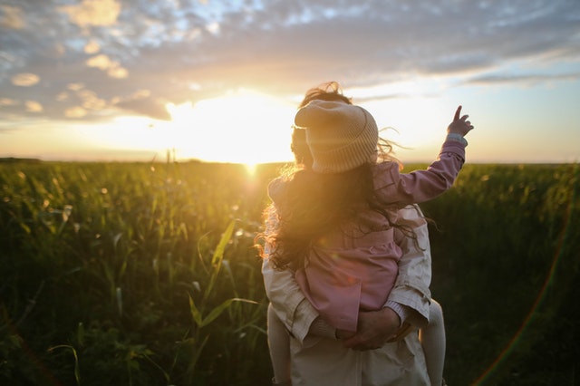 little girl pointing out the sky