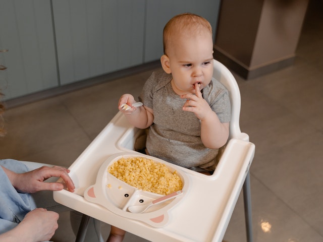 little baby boy grumpy during lunch